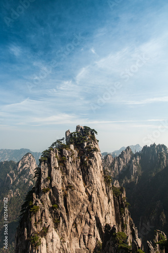 Huangshan Mountain Range - Anhui Province - China. Scenic landscape with steep cliffs and trees during a sunny day