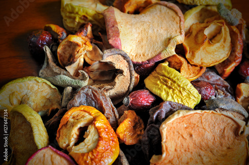 apple, pear, rose apricots dry slices on wooden board