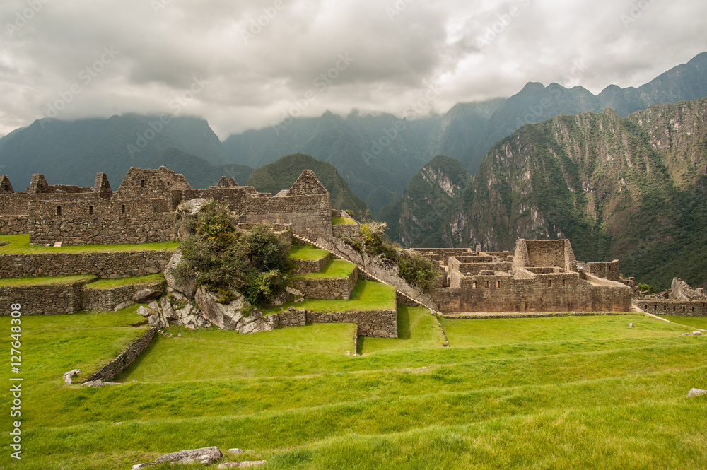 The ancient city of Machu Picchu, Peru. Overlooking ruins on the Inca citadel in the Andes Mountains and the river valley below.