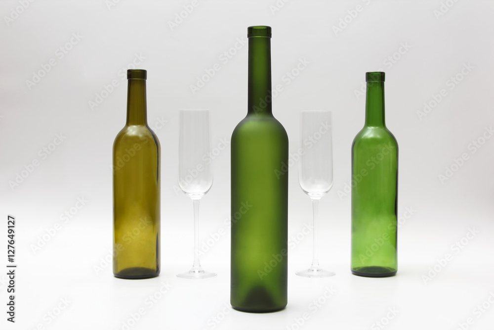 empty bottles and wine glasses on a white background empty bottles and wine glasses on a white background