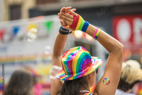 Woman wearing colorful rainbow accessories during pride parade