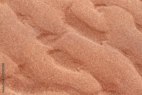 Ripples in red beach sand