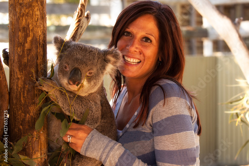 Attractive woman holding a koala bear in Australia