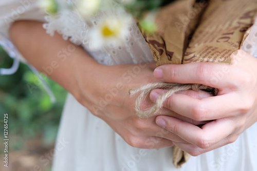Close up hand of bride holding a bouquet of flowers