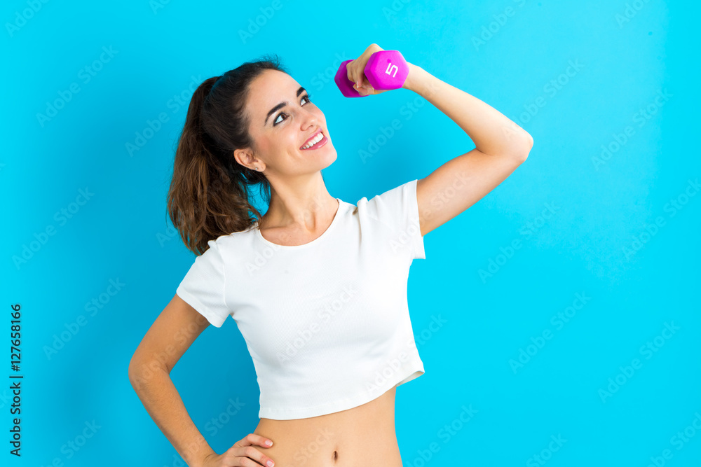 Woman working out with dumbbell Woman working out with dumbbell