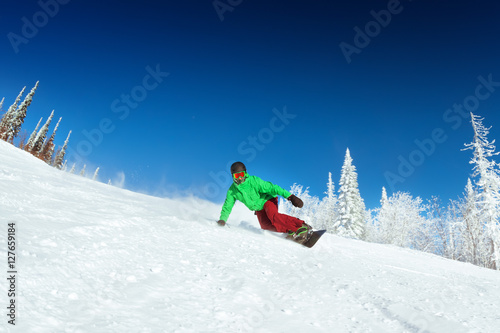 Snowboarder rides on slope snowboarding