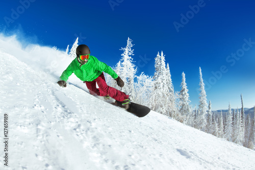 Active snowboarder snowboarding rides closeup