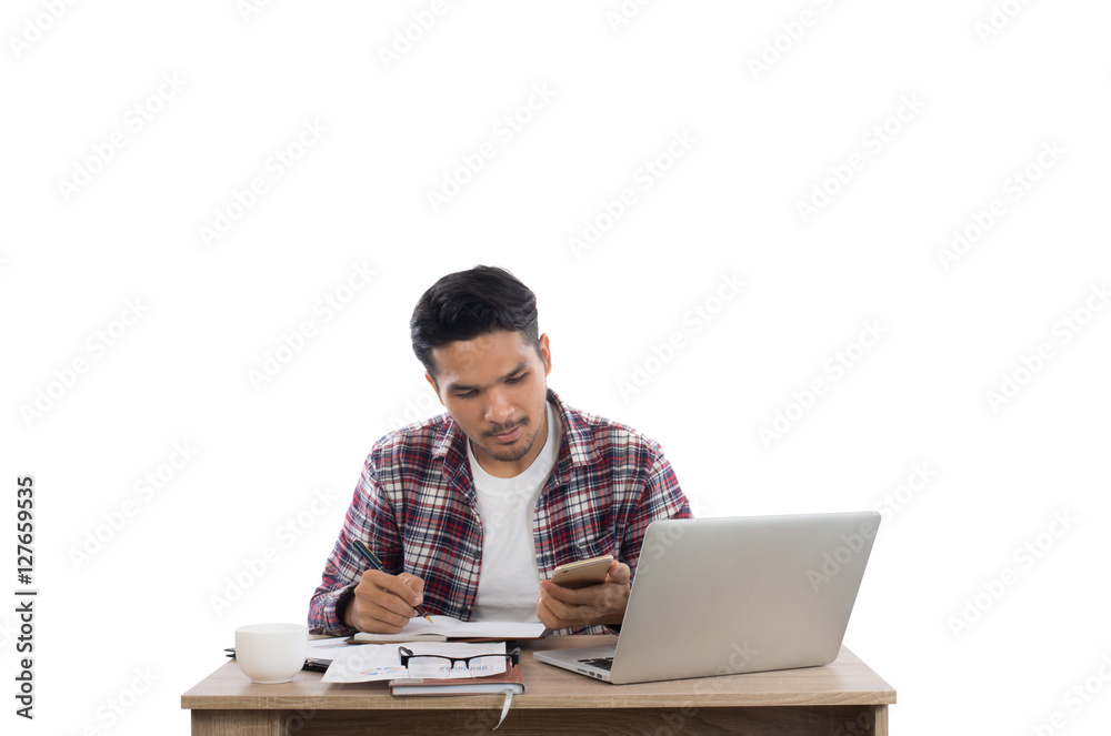 Businessman looking at his phone while working with laptop in of Businessman looking at his phone while working with laptop in of