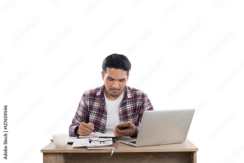Businessman looking at his phone while working with laptop in of Businessman looking at his phone while working with laptop in of