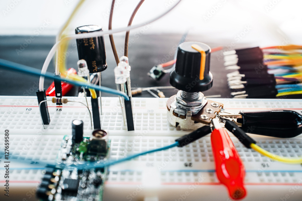 Prototyping electronic board with components and wires. Science experiment, robotics development concept Prototyping electronic board with components and wires. Science experiment, robotics development concept