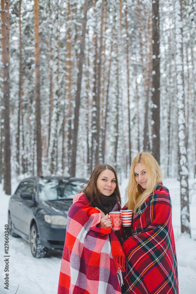 two girls sheltered red plaid hold mugs