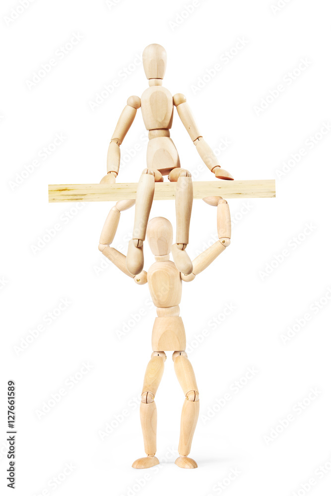Man holds over the head a wooden board where sits another person. Abstract image with a wooden puppet Man holds over the head a wooden board where sits another person. Abstract image with a wooden puppet