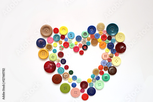 Heart of buttons isolated on a white background. Sewing with love