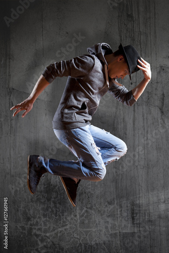 Man break dancing on wall background