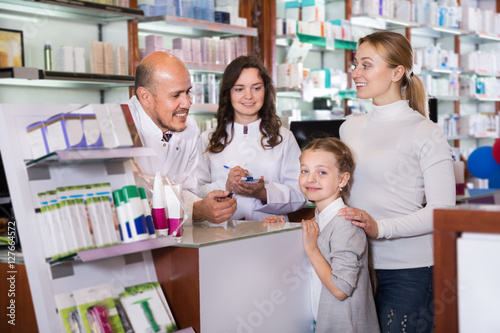 Mother with a girl in the pharmaceutical store
