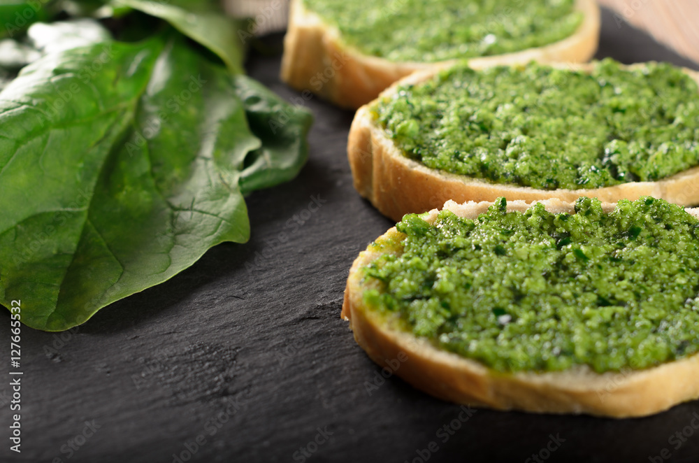 Bruschetta with pesto sauce on a slate plate Bruschetta with pesto sauce on a slate plate