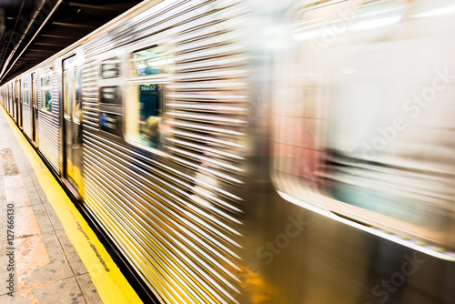 New York City subway train leaving its station - motion blur as the train passes