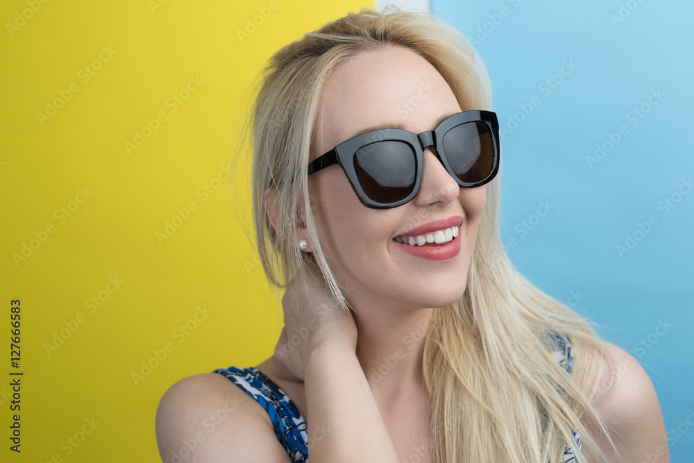 Fototapeta premium beautiful young blonde woman with elegant sunglasses posing in a
