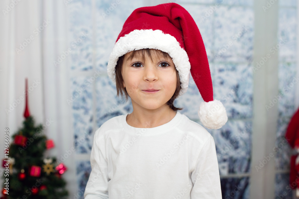 Christmas portrait of cute little preschool boy, eating cookies Christmas portrait of cute little preschool boy, eating cookies