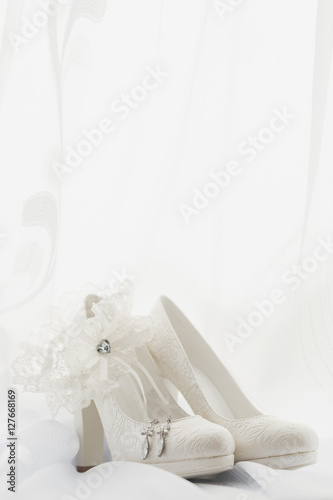 macro photo of white wedding shoes