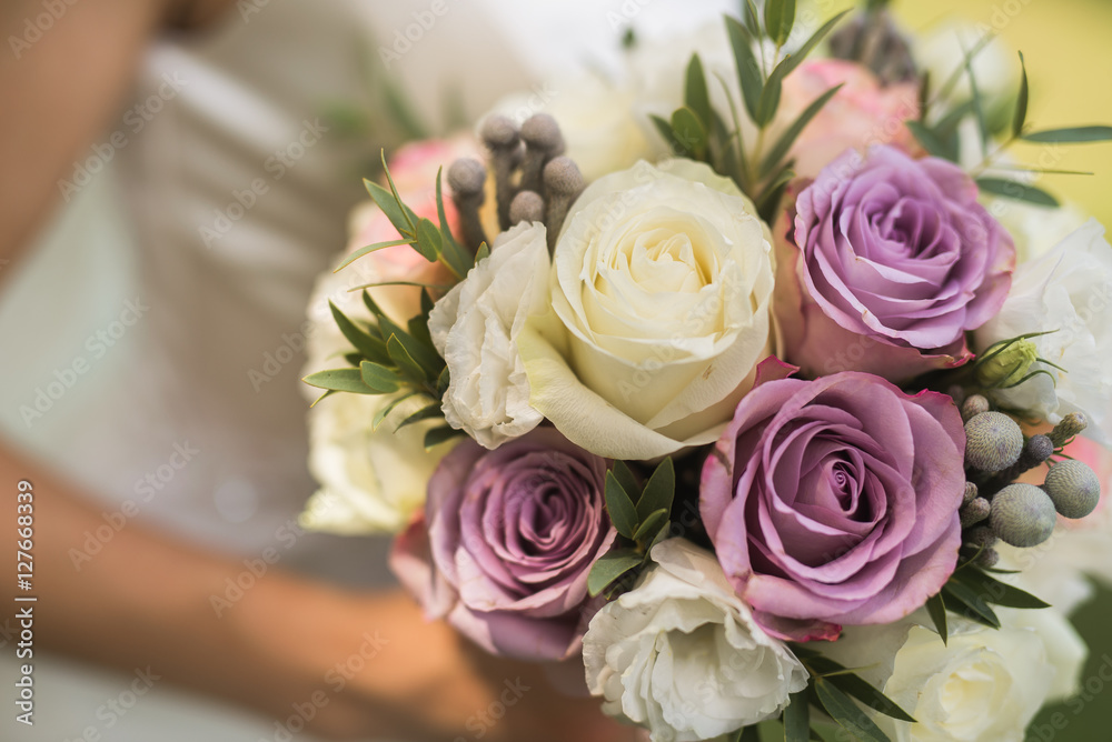 closeup photo of bride holding a flower bouquet