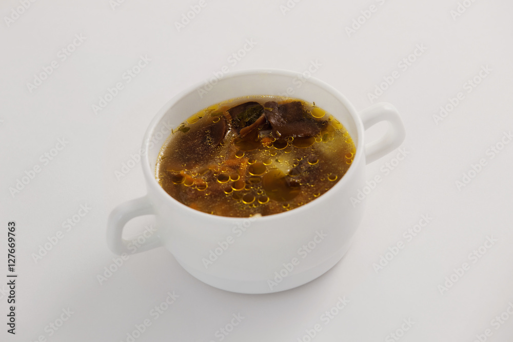 Closeup image of mushroom soup bowl isolated at white background Closeup image of mushroom soup bowl isolated at white background