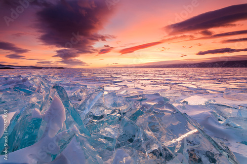 Fototapeta Naklejka Na Ścianę i Meble -  Colorful sunset over the crystal ice of Baikal lake