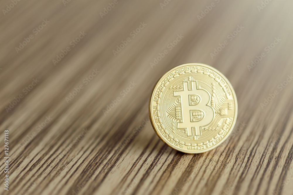 Golden Bitcoins on a wooden background Golden Bitcoins on a wooden background