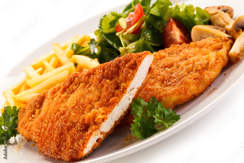 Fried pork chop, French fries and vegetables Fried pork chop, French fries and vegetables