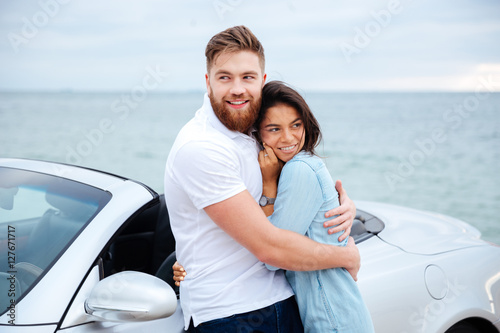 Young beautiful couple in love standing at car © Drobot Dean