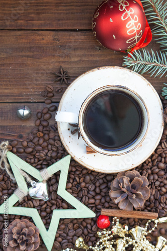 A cup of coffee. Coffee beans on the wooden background. Christmas still life. photo