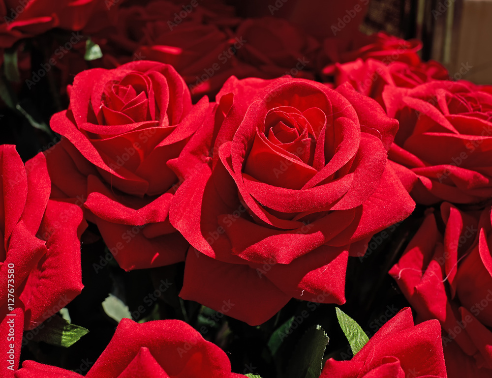 vibrant red fake rose flowers closeup vibrant red fake rose flowers closeup