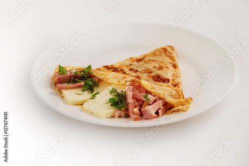 Traditional Russian meal blin stuffed with ham and cheese 