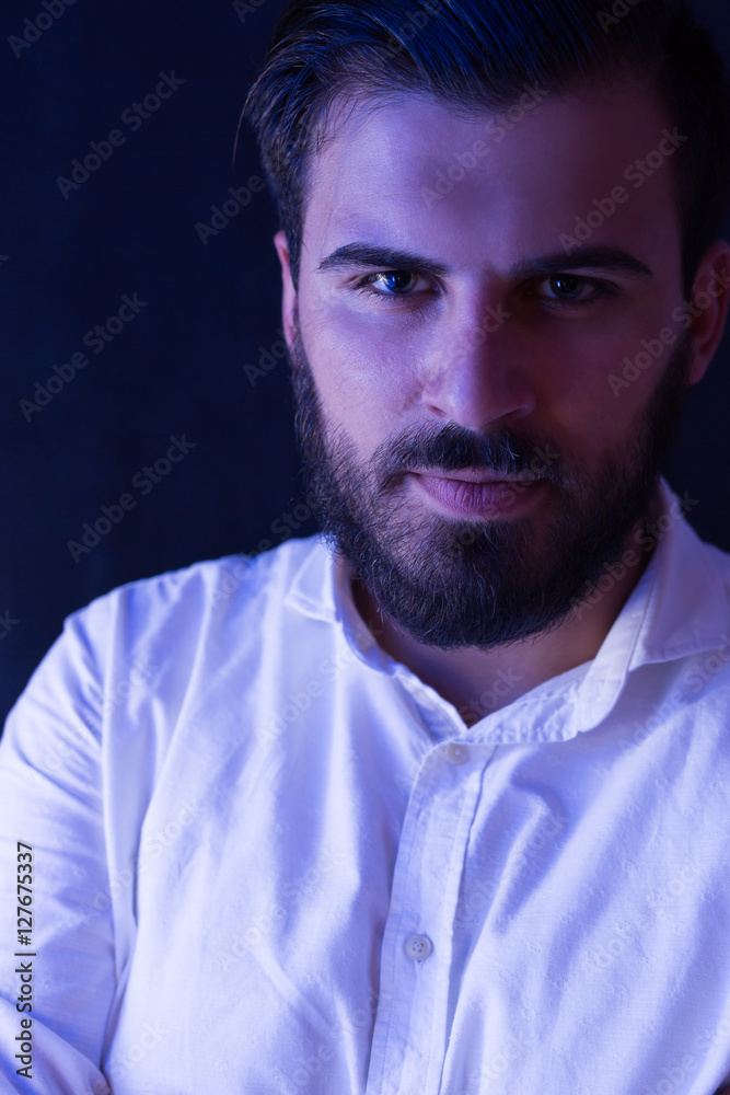 Obraz premium Portrait of a bearded man light by fluorescent light. Bearded m