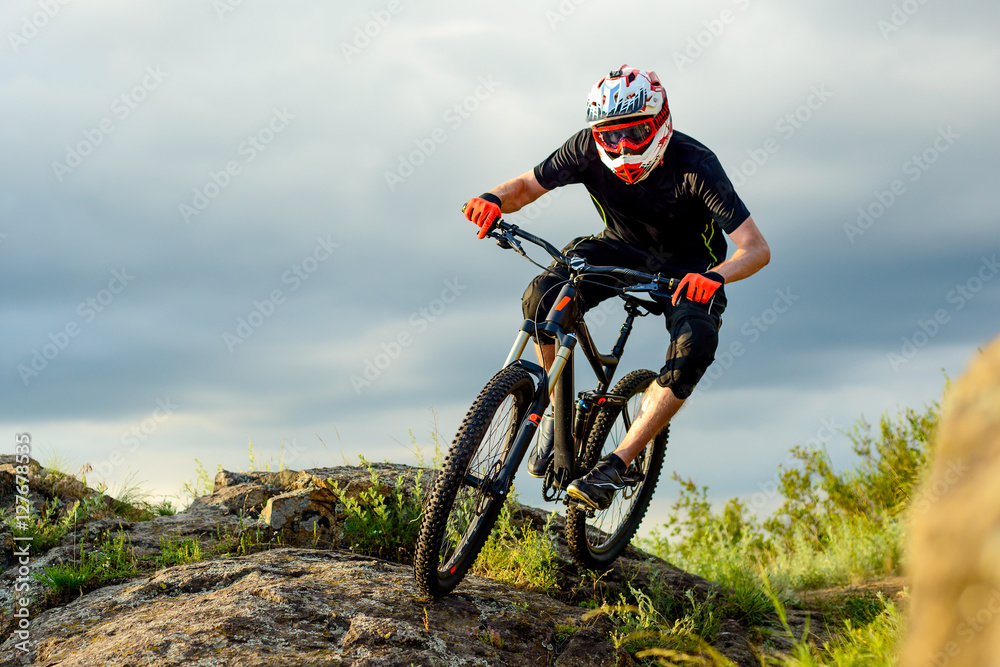 Professional Cyclist Riding the Bike on the Rocky Trail. Extreme Sport. Professional Cyclist Riding the Bike on the Rocky Trail. Extreme Sport.