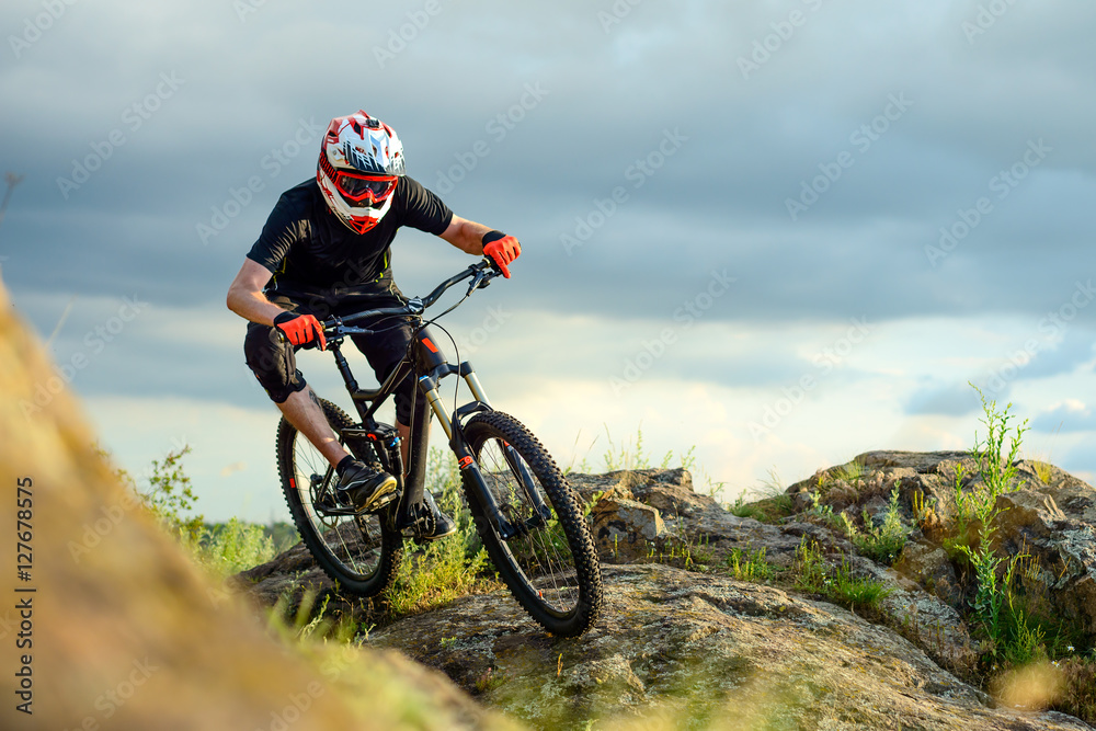 Professional Cyclist Riding the Bike on the Rocky Trail. Extreme Sport.