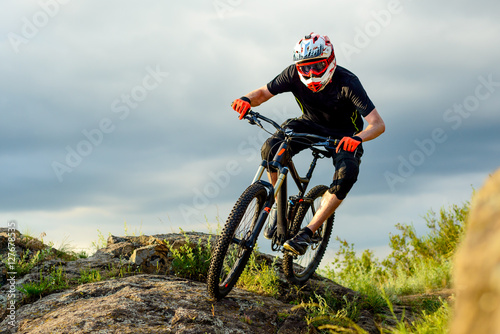 Professional Cyclist Riding the Bike on the Rocky Trail. Extreme Sport.