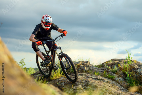 Professional Cyclist Riding the Bike on the Rocky Trail. Extreme Sport.