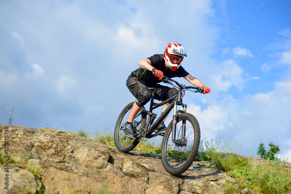 Professional Cyclist Riding the Bike Down Rocky Hill. Extreme Sport. Professional Cyclist Riding the Bike Down Rocky Hill. Extreme Sport.