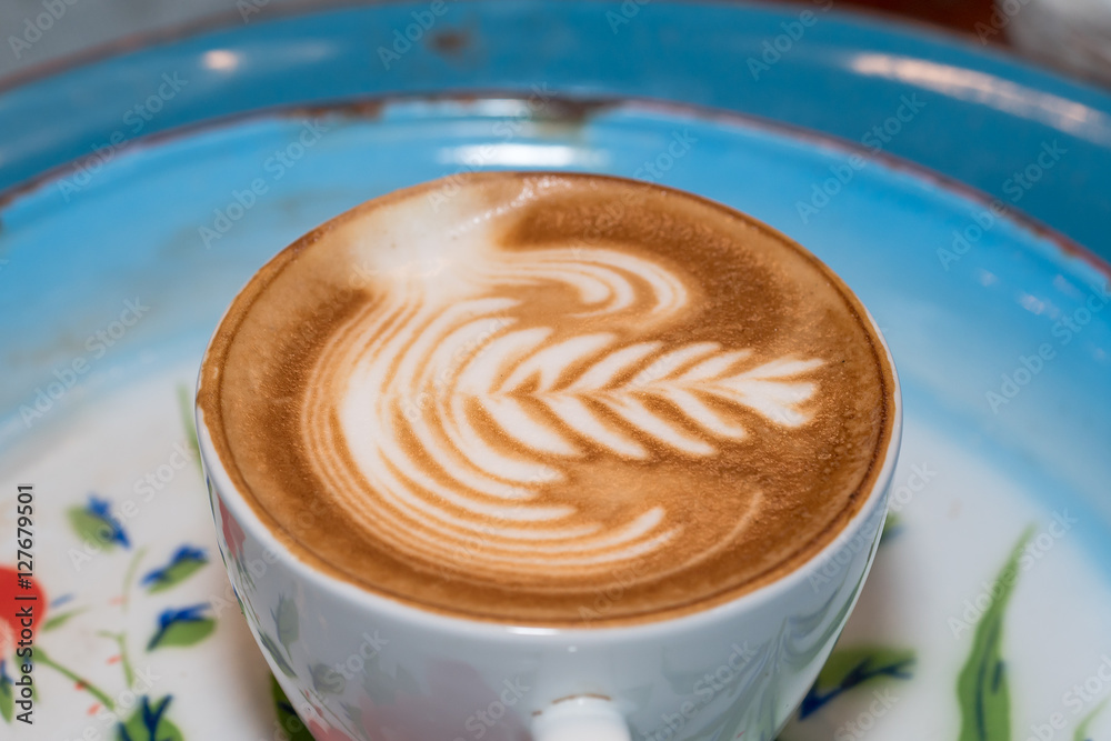 A Cup of hot latte art coffee on wooden table
A Cup of hot latte art coffee on wooden table