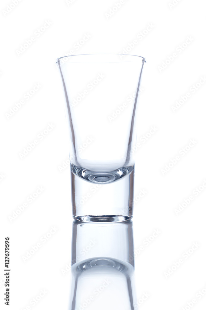 Vodka glass isolated on white background with a reflection. Vodka glass isolated on white background with a reflection.