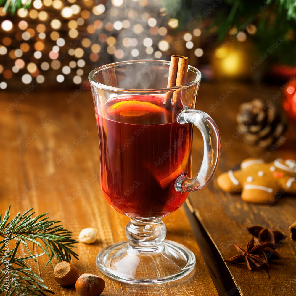 Mulled wine for Christmas Eve celebration party by Christmas tree. Hot traditional winter drink for New Year eve. Mulled wine for Christmas Eve celebration party by Christmas tree. Hot traditional winter drink for New Year eve.