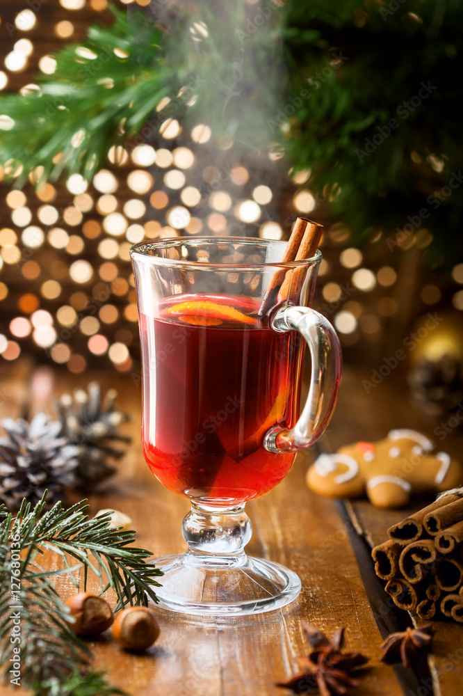 Glass of mulled wine with citrus fruits and cinnamon. Christmas holiday drink. Glass of mulled wine with citrus fruits and cinnamon. Christmas holiday drink.