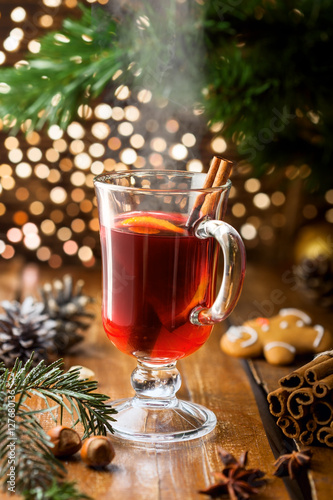 Glass of mulled wine with citrus fruits and cinnamon. Christmas holiday drink.