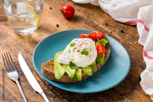 Poached egg and avocado on toast. Healthy breakfast or lunch