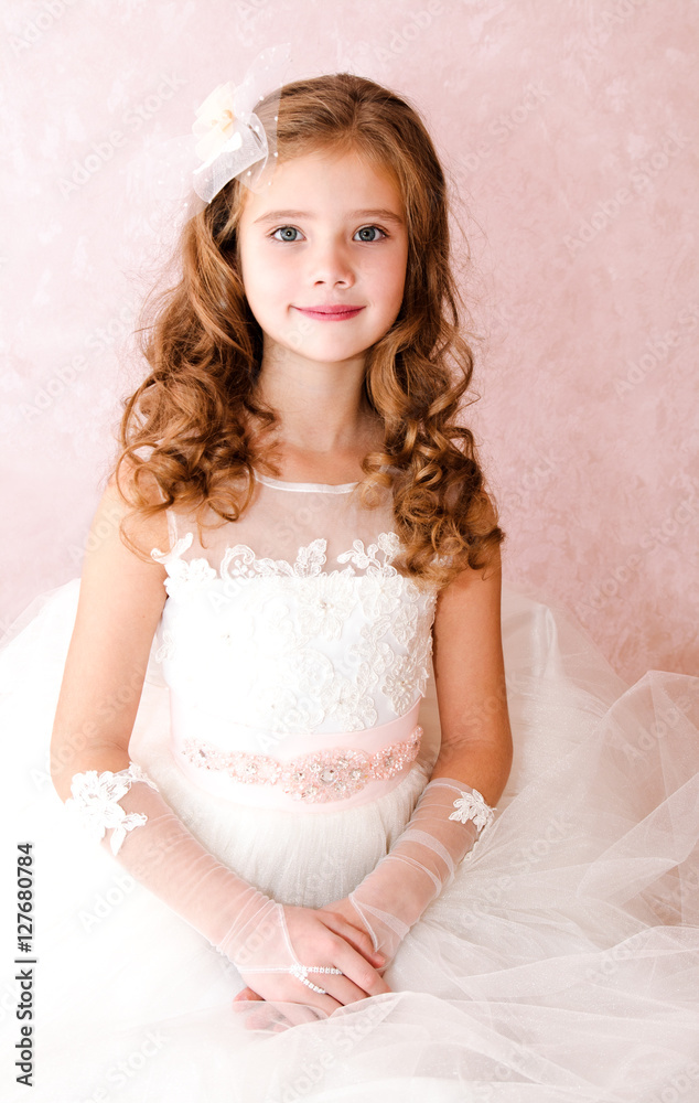 Adorable smiling little girl in white princess dress Adorable smiling little girl in white princess dress