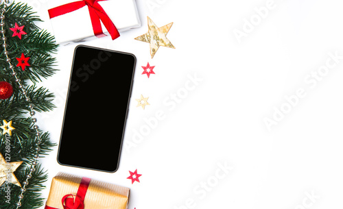 Smartphone in a Christmas white background with tree, gift and d