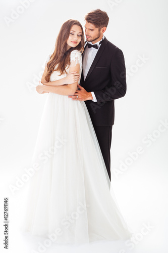 Full-length image of pretty newlyweds