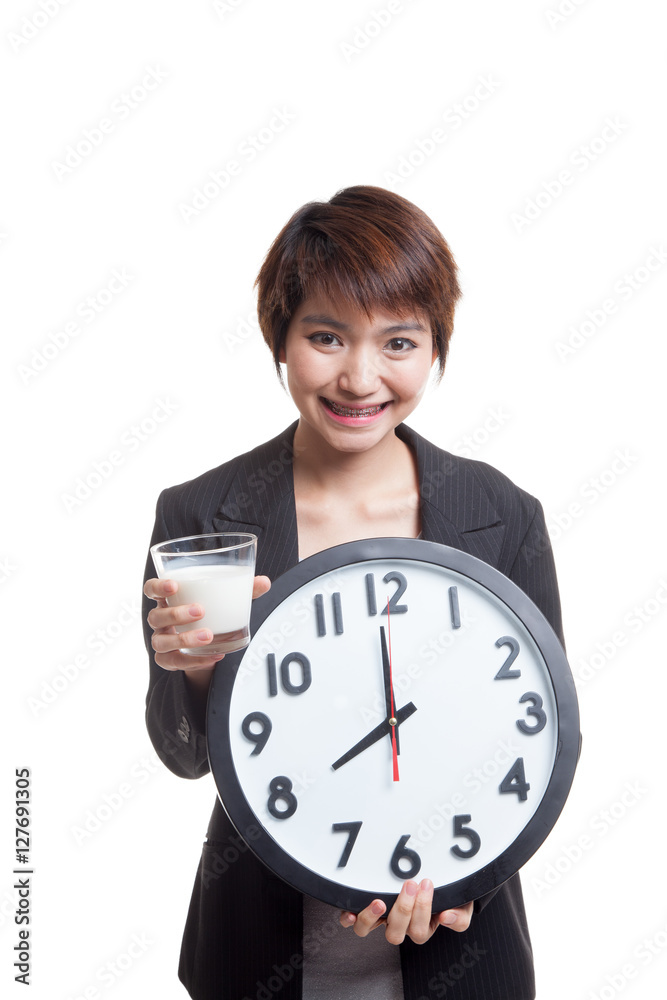 Healthy Asian woman drinking glass of milk hold clock. Healthy Asian woman drinking glass of milk hold clock.