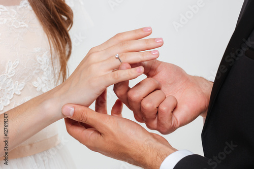Man putting engagement ring on his girlfriend finger